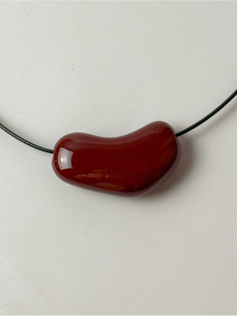 Burgundy Red Sculptural Bean Pendant Necklace Black Cord Modern Minimalist